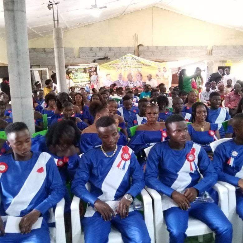 Graduating class seated in blue and white gowns